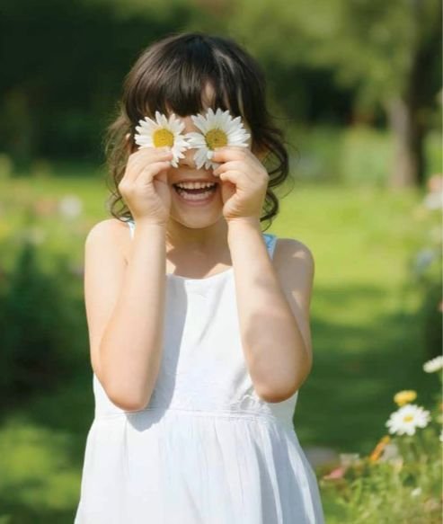 Child carrying a flower at Prestige Garden Trails Mira Road Dahisar